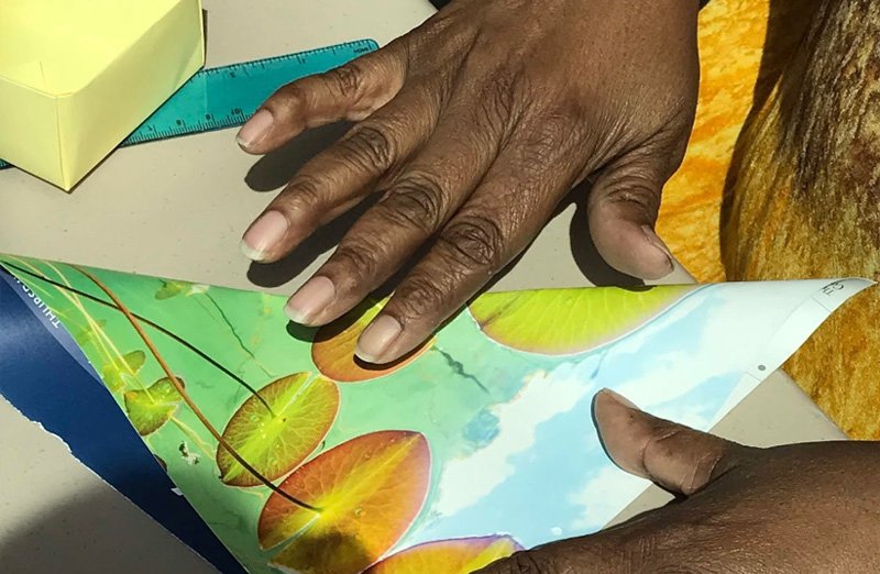 Woman's hands showing how to fold a soul box