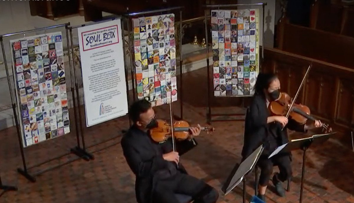 String quartet plays in front of Soul Box panels